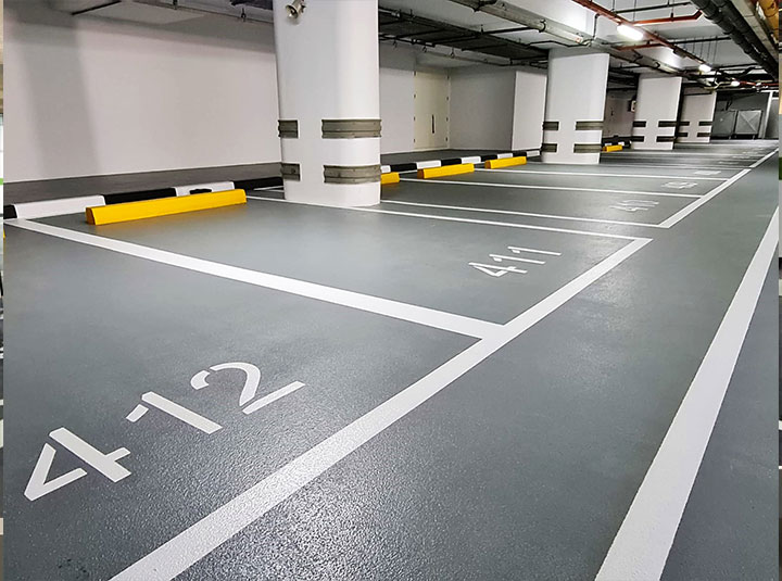 Completed epoxy car-park flooring with bay numbers and white line marking